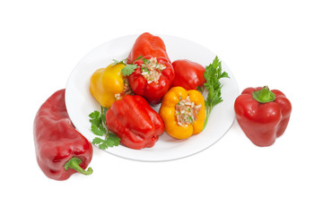 Stuffed bell peppers and two fresh peppers beside