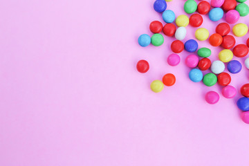 Colorful candies on pink