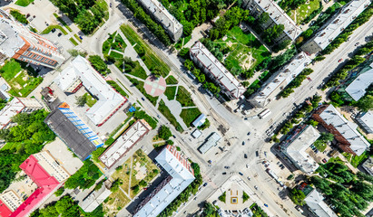 Aerial city view with crossroads and roads, houses, buildings, parks and parking lots, bridges. Helicopter drone shot. Wide Panoramic image.