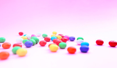Colorful candies on pink