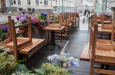 Fototapeta na wymiar Tables of a street cafe after a rain