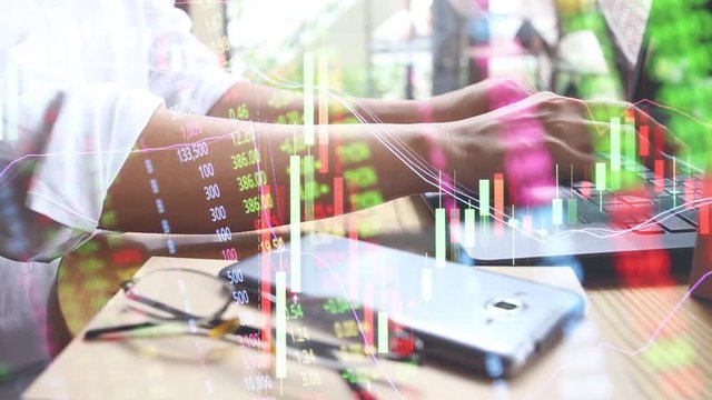 business finance concept with woman use laptop with stock market graph chart double exposure