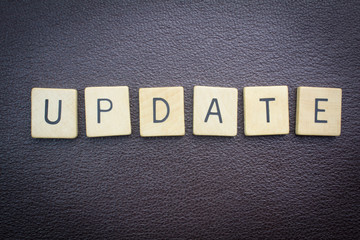 Update word concept for website on dark leather background