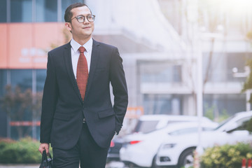 young businessman walking outside office