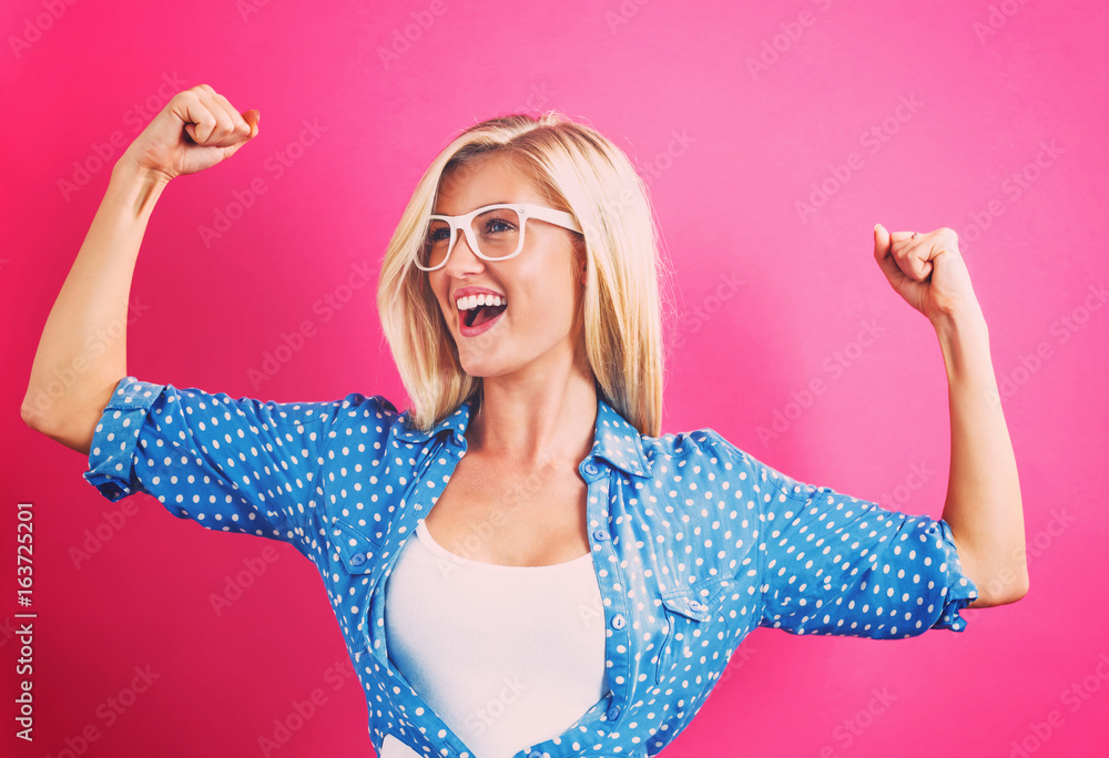 Sticker Powerful young woman on a pink background