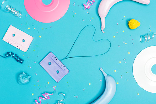 Music flat lay objects with vinyl records and cassette tapes on a blue background