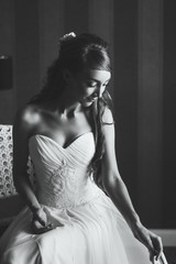 Fototapeta premium Beautiful black and white portrait of young woman in wedding dress