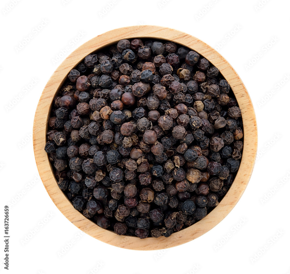 Sticker black pepper in wooden bowl isolated on white background