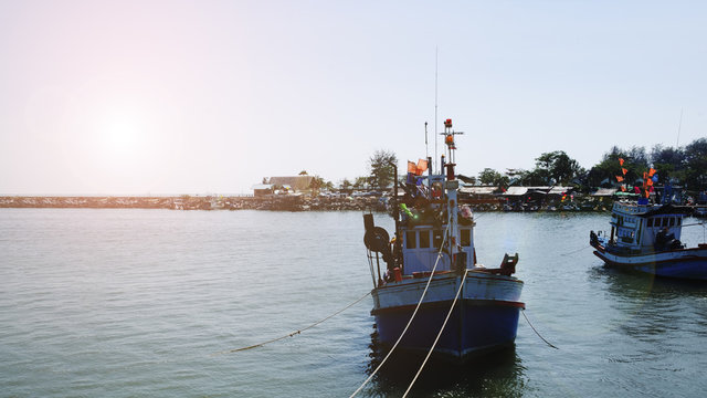 Thai fishing boat at pier habor in the morning