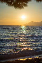 Sea waves and ripples at sunset background