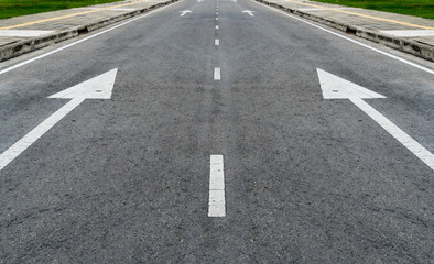 Asphalt road with arrow sign