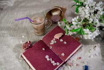 A book for notes with a pencil with hot cocoa in flower petals and crusshed macaroons