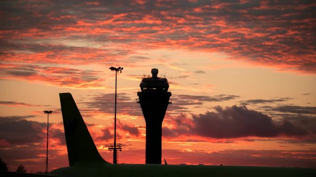 Timelapse view of International airport at sunset - control tower