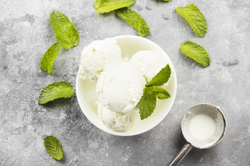 Mint ice cream in bowl on a gray background. Top view. Food background