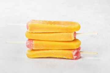 Multi-colored popsicles on a white background