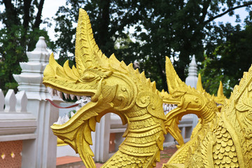 Fototapeta premium Golden Naga ladder sculpture in Lao temple, Laos