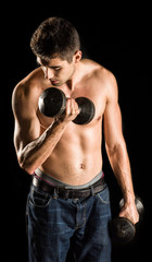 Fototapeta na wymiar Young Man Working Out Biceps - Dumbbell Concentration Curl