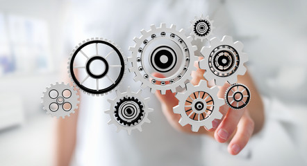 Businessman touching floating gear icons in his hand 3D rendering