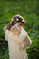 beautiful girl with a rabbit in the woods