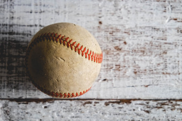 old Baseball and glove on wood background with filter effect retro vintage style