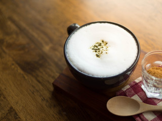 Green tea latte on wood table