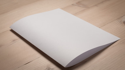 White blank paper notepad on wooden table.