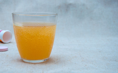 Effervescent tablet (vitamin) in a glass of water.
