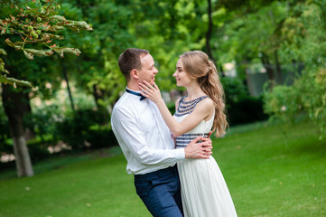 Fototapeta premium A married couple is walking and hugging in the park.