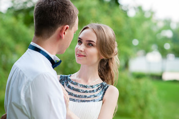 Fototapeta premium A married couple is walking and hugging in the park.