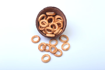 Salty Mini Pretzels with Salt in a Bowl, small bagel - homemade organic snack for beer in wood bowl isolated white background