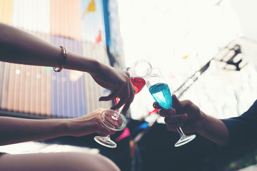 Portrait of happy young friends having fun and drinking together.