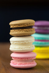 Tasty macaroons with almond on wooden background