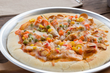 Close up of tasty homemade seafood topped pizza fusion food style on tray