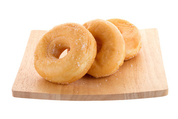 Sugary donuts on a wooden plate isolated on a white background