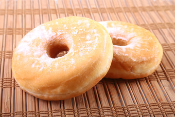 Homemade Doughnuts with Jelly filled and powdered sugar on Bamboo tablecloth. Selective focus.