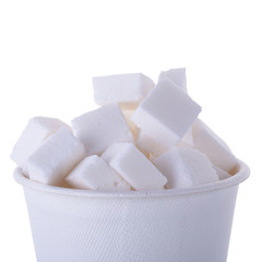 Sugar cubes in wooden spoon isolated on a white background