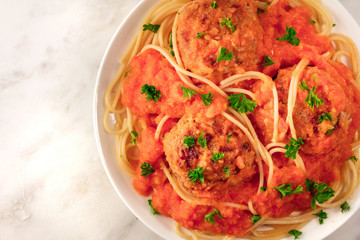 Meatballs and pasta dish, closeup from above with copyspace