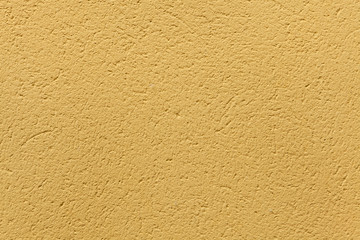 Yellow ochre painted stucco wall. Background texture.