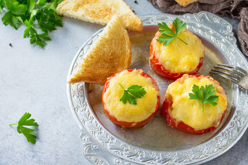 Stuffed tomatoes. Tomatoes baked with cheese and chicken, served with croutons of white bread.
