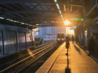 Blur Unidentified people waiting sky train in the morning with flare