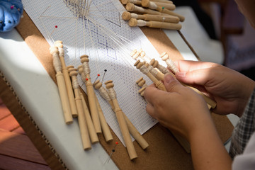 Skilled female hands at the traditional lace making crafts,bobbin lace making
