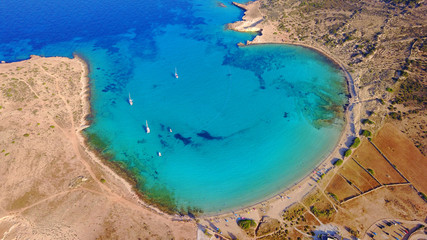 Obraz premium Aerial drone photo of famous caves of Ksylobatis near Pori beach, Koufonissi island. Cyclades, Greece