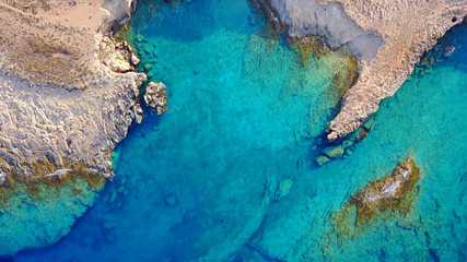 Aerial drone photo of famous caves near Pori beach, Koufonissi island. Cyclades, Greece