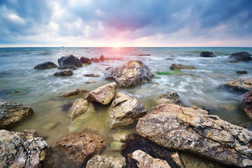 Fototapeta na wymiar Beautiful seascape. Stones on sea shore. Nature composition.