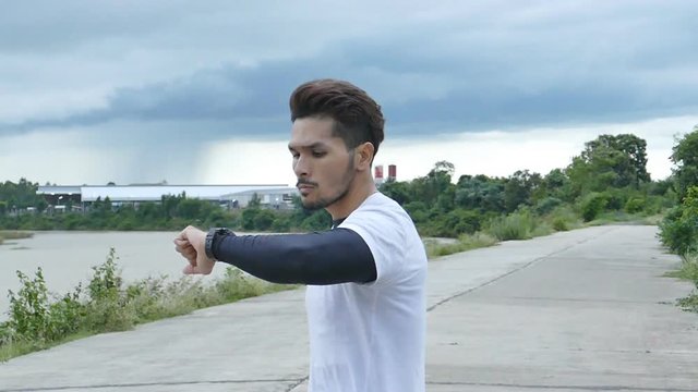 Man jogging on the river side while rain coming, slow motion shot at 120fps.