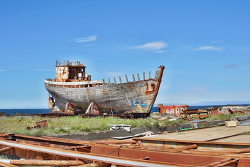 Rusty wooden and metal shipwreck in the Icelandic dry dock in the Akranes town as a symbol of...