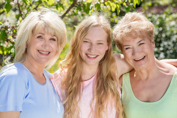 Three generations of women. Family spending time together in the garden