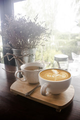 Coffee cup and tea cup in coffee shop - vintage tone hipster style 