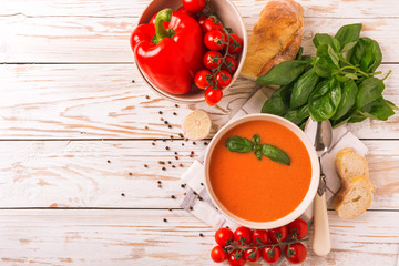 Italian tomato soup gazpacho with basil, tomatoes and baguette
