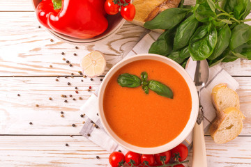 Italian tomato soup gazpacho with basil, tomatoes and baguette